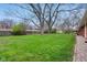 A spacious backyard with a large lawn and mature trees at 4601 N Ball Ave, Muncie, IN 47304