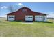 Barn featuring multiple white doors and a red exterior at 4611 E Us Highway 36, Markleville, IN 46056