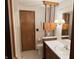 Bathroom showcasing white tile, dark wood vanity, and classic fixtures at 4611 E Us Highway 36, Markleville, IN 46056