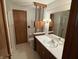 Traditional bathroom featuring a vanity with a white countertop and wood cabinets at 4611 E Us Highway 36, Markleville, IN 46056