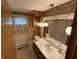 A bathroom with a vanity, decorative mirror, and retro wallpaper at 4611 E Us Highway 36, Markleville, IN 46056