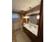 A bathroom with a vanity, decorative mirror, and retro wallpaper at 4611 E Us Highway 36, Markleville, IN 46056
