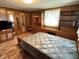 This bedroom features wood paneling, built-in shelves, and a quaint, cozy vibe at 4611 E Us Highway 36, Markleville, IN 46056