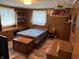 Bedroom with wood-paneled walls, built-in desk, and cozy vintage lighting at 4611 E Us Highway 36, Markleville, IN 46056
