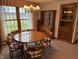 Charming dining area featuring a round wooden table, chairs, and a traditional hutch for elegant storage at 4611 E Us Highway 36, Markleville, IN 46056