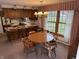 Inviting dining area featuring a round wooden table and chairs, with large windows offering natural light at 4611 E Us Highway 36, Markleville, IN 46056