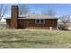 Brick home exterior featuring a chimney and lawn at 4611 E Us Highway 36, Markleville, IN 46056