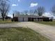 Spacious front exterior view of the brick home, including driveway and two-car garage at 4611 E Us Highway 36, Markleville, IN 46056
