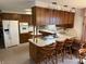 Kitchen with wooden cabinets, breakfast bar and modern appliances at 4611 E Us Highway 36, Markleville, IN 46056