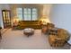 Cozy living room with a comfortable sofa, floral armchairs, and natural light from large windows at 4611 E Us Highway 36, Markleville, IN 46056