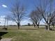 View of the flat open property with mature trees near a quiet country road at 4611 E Us Highway 36, Markleville, IN 46056