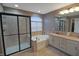 Bathroom with a separate shower, soaking tub, double vanity with granite countertop, and tile flooring at 4733 Mecklenburg Dr, Plainfield, IN 46168