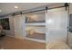 Built-in bunk beds featuring sliding barn doors create a cozy and stylish sleeping space with plush bedding and décor at 4733 Mecklenburg Dr, Plainfield, IN 46168
