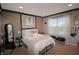 Charming bedroom with a brick accent wall, modern decor, and a bright window, creating a cozy retreat at 4733 Mecklenburg Dr, Plainfield, IN 46168