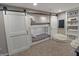 Charming bunk beds with sliding barn doors provide a unique sleeping space, complemented by a cozy beanbag chair and shelving at 4733 Mecklenburg Dr, Plainfield, IN 46168