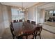 Elegant dining room with a large table, stylish chandelier, and decorative wallpaper at 4733 Mecklenburg Dr, Plainfield, IN 46168
