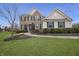 Charming two-story home featuring a manicured lawn and walkway leading to the front entrance at 4733 Mecklenburg Dr, Plainfield, IN 46168