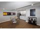 Kitchenette with white cabinetry, stainless steel appliances, and a dining table with seating near colorful wall art at 4733 Mecklenburg Dr, Plainfield, IN 46168