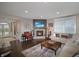 Inviting living room features a stone fireplace, plush seating, and ample natural light at 4733 Mecklenburg Dr, Plainfield, IN 46168