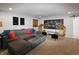 Comfortable living room featuring a sectional sofa, hanging chairs, and a bicycle art piece at 4733 Mecklenburg Dr, Plainfield, IN 46168