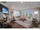 Bright living room with a cozy fireplace, large sectional sofa, and hardwood floors at 4733 Mecklenburg Dr, Plainfield, IN 46168