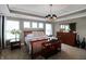 Inviting main bedroom with tray ceilings, ample natural light, and stylish wooden furniture at 4733 Mecklenburg Dr, Plainfield, IN 46168