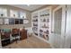 Bright home office with custom built-in shelving and a traditional desk at 4733 Mecklenburg Dr, Plainfield, IN 46168