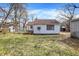Cozy home featuring a spacious backyard with a privacy fence and mature trees at 4906 S State Ave, Indianapolis, IN 46227