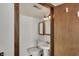 A small, traditional bathroom with a pedestal sink and toilet at 4906 S State Ave, Indianapolis, IN 46227