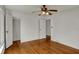A spacious bedroom with hardwood floors, white walls, and closet space at 4906 S State Ave, Indianapolis, IN 46227