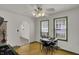 Bright dining area features light wood floors, an elegant ceiling fan, and windows providing plenty of natural light at 4906 S State Ave, Indianapolis, IN 46227