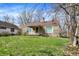 Attractive single-Gathering home features a well-maintained lawn and stone exterior, nestled among mature trees at 4906 S State Ave, Indianapolis, IN 46227
