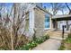 Charming home's exterior with stone accents, a covered entryway, and colorful spring flowers blooming along the walkway at 4906 S State Ave, Indianapolis, IN 46227