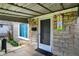 Inviting front porch featuring a stone facade, a covered entrance, and a charming decorative birdhouse at 4906 S State Ave, Indianapolis, IN 46227
