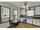Charming kitchen features white cabinets, a small table, and natural light from two windows, creating a warm atmosphere at 4906 S State Ave, Indianapolis, IN 46227
