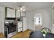 Traditional kitchen with white cabinets, stainless steel appliances, and a cozy dining area, perfect for Gathering meals at 4906 S State Ave, Indianapolis, IN 46227