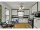 Spacious kitchen with white and green accents, featuring modern appliances and a dining area for comfortable Gathering living at 4906 S State Ave, Indianapolis, IN 46227
