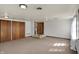 A finished living room with carpeted floors and access to a bathroom at 4906 S State Ave, Indianapolis, IN 46227