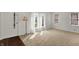 Bright and airy living room with large windows, plush carpeting, and plenty of natural light at 4906 S State Ave, Indianapolis, IN 46227
