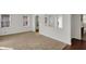 Cozy living space featuring hardwood flooring, neutral walls, and an archway leading to a bright adjacent room at 4906 S State Ave, Indianapolis, IN 46227