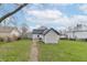 The backyard with a patio, shed, and lush green lawn under a bright, partly cloudy sky at 508 Mount St, Greenfield, IN 46140
