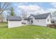 Backyard with detached garage, patio area with furniture, and well-kept green lawn under a sunny sky at 508 Mount St, Greenfield, IN 46140