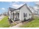 Attractive house featuring an inviting porch with chairs, fresh landscaping, and sidewalk at 508 Mount St, Greenfield, IN 46140