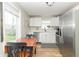 Bright eat-in kitchen features white cabinets, stainless appliances and a wood dining table at 508 Mount St, Greenfield, IN 46140