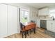 Eat-in kitchen showcasing a wood dining table set by a window and white cabinetry at 508 Mount St, Greenfield, IN 46140