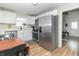 Bright kitchen features white cabinets, stainless steel appliances, and a wood dining table at 508 Mount St, Greenfield, IN 46140