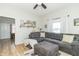 Bright living room features a plush gray sofa, modern ceiling fan and wood-look flooring at 508 Mount St, Greenfield, IN 46140