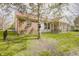 Home backyard featuring partial fencing, screened-in porch, brick, and mature trees at 5417 Kerns Ln, Indianapolis, IN 46268