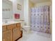 This bright bathroom features a sink and vanity, toilet, and patterned shower curtain at 5417 Kerns Ln, Indianapolis, IN 46268