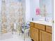 Clean bathroom with a shower, tile floor, and bright lighting creating a comfortable and functional space at 5417 Kerns Ln, Indianapolis, IN 46268